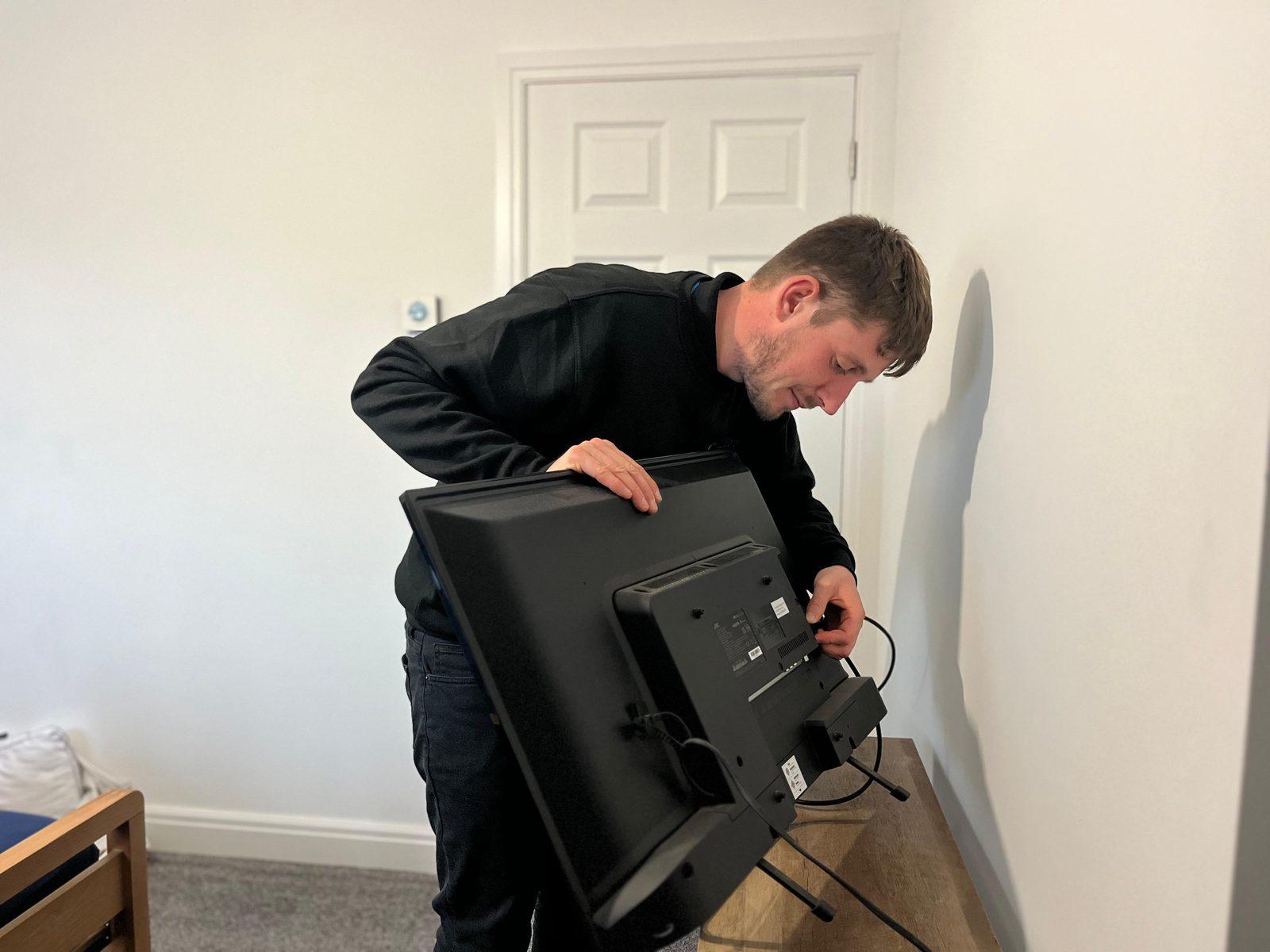 TechMates Expert connecting cables to a monitor for a customer in Boston, Lincolnshire